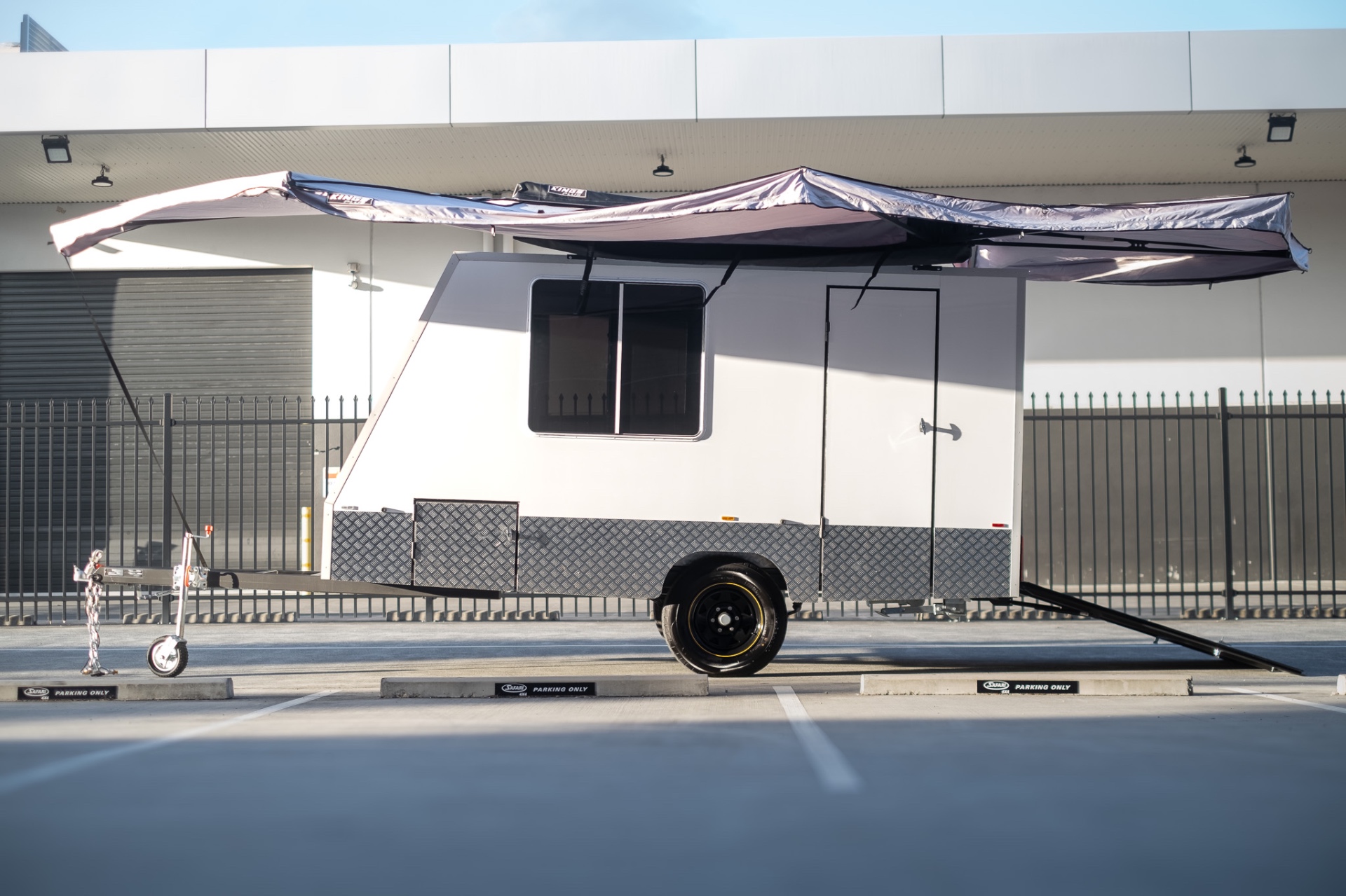 Full side profile of the MotoCampers 001 trailer with 270 degree awning deployed
